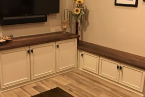 Custom cabinet area with bench seating and black walnut wood tops.